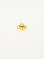 Gold ring with a gemstone on a white background