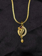 Gold necklace with a decorative pendant on a black background