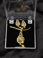Gold necklace and earrings set in a clear box on a black background