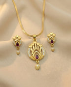 Gold necklace and earrings set on a mannequin