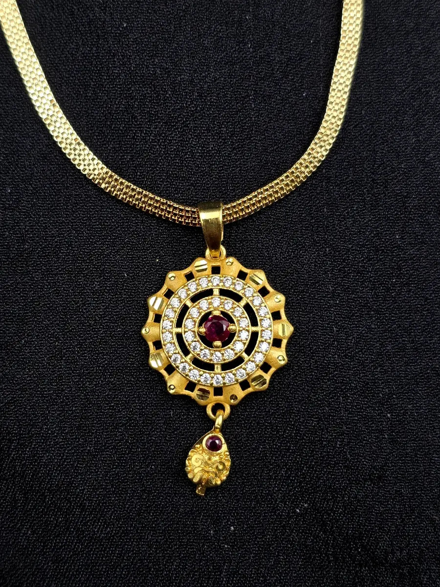 Gold necklace with a decorative pendant on a black background