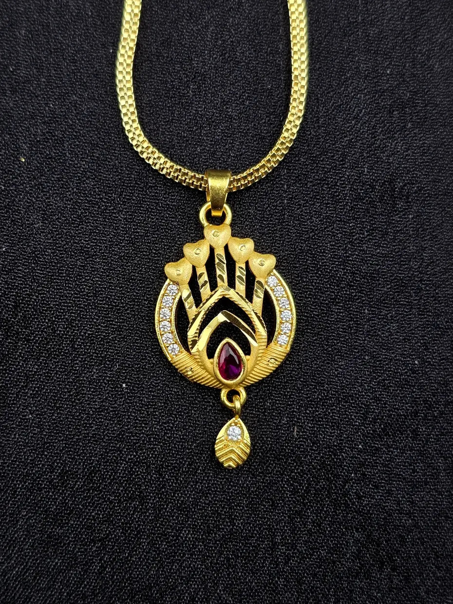 Gold necklace with a decorative pendant on a black background