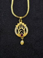 Gold necklace with a decorative pendant on a black background