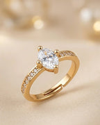 Gold ring with a diamond on a beige background